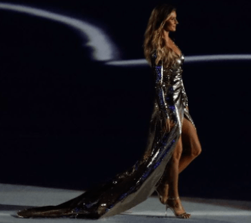 Gisele Bündchen wearing a gown while walking down the runway