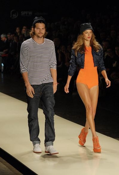 Alessandra Ambrosio walking the runway with Ashton Kutcher at São Paulo Fashion Week in 2011