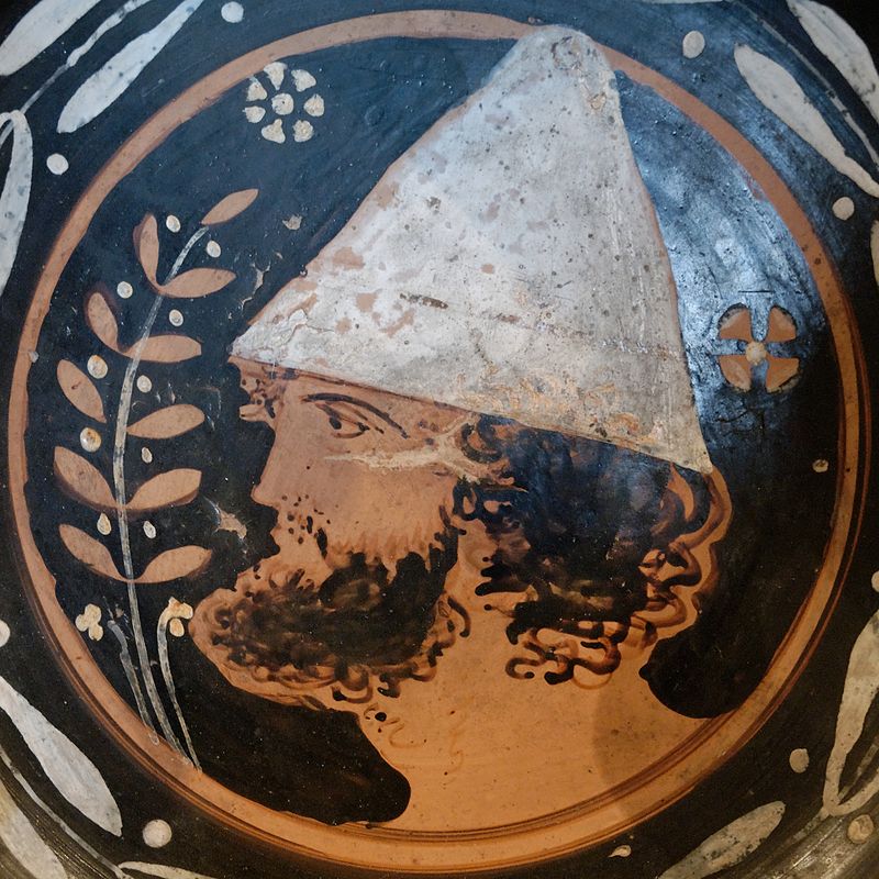 an Apulian red figure depicting a m an wearing the conical pilos hat