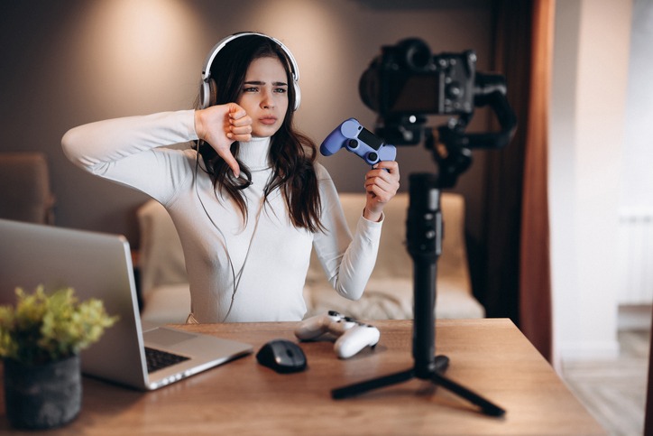 A gamer wearing turtleneck sweater in front of a camera