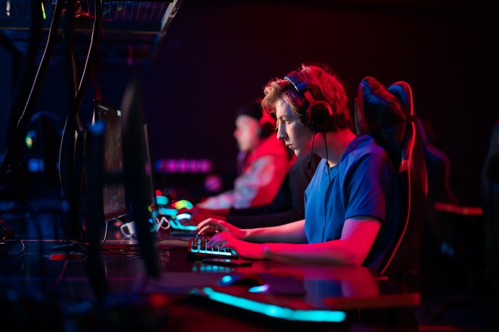 A professional esports player wearing headphones and sitting on a gaming chair